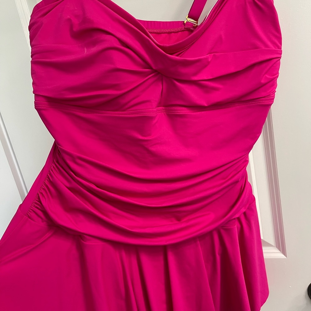 Fuschia skirted one-piece bathing suit.